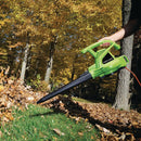 Corded electric leaf blower clearing leaves in the garden