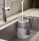 Kohler Haku pull-down faucet filling glass with water